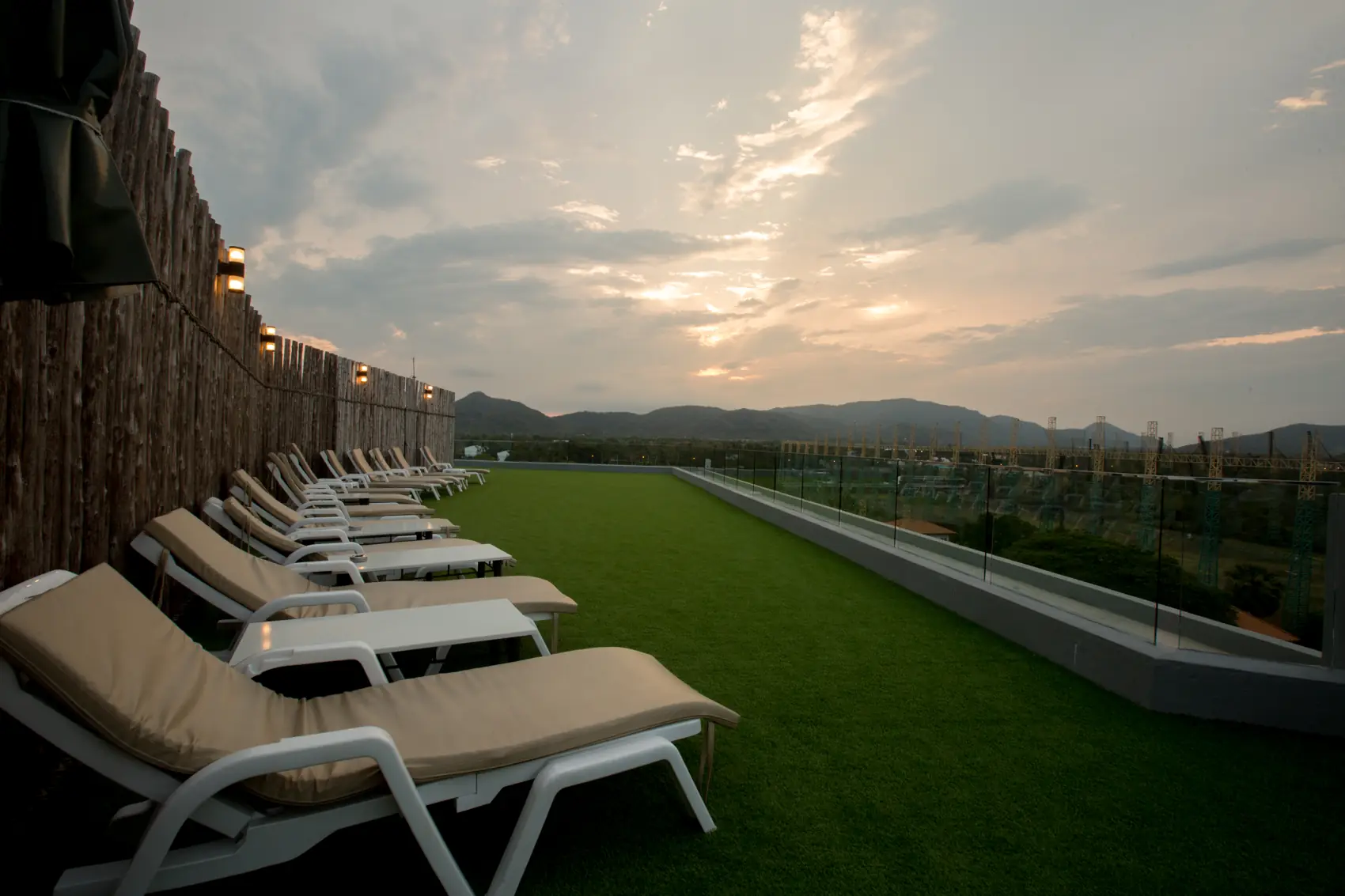 Rooftop pool at sunset and night